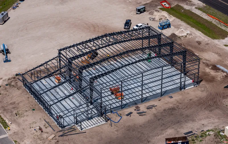 Aerial view of a completed steel building frame with bracing in place