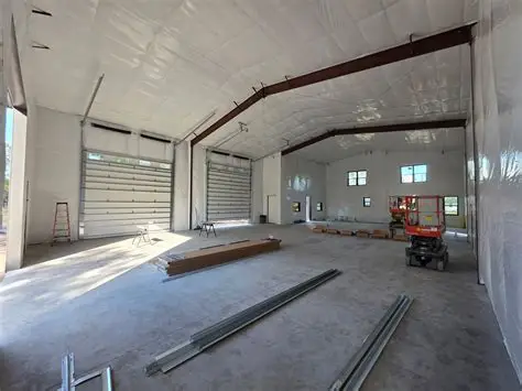 Interior of a steel building lined out in white, with the purlins hidden and the main frame still visible