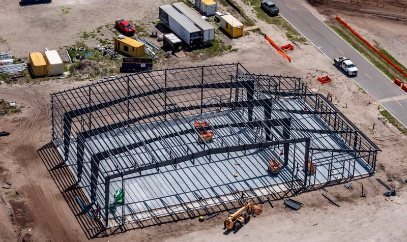 Aerial view of a completed steel frame beside the access road